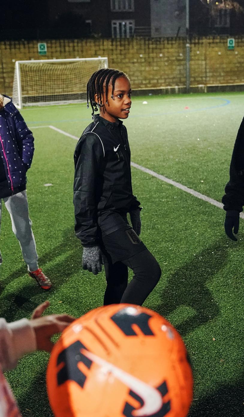 Girls playing football outside